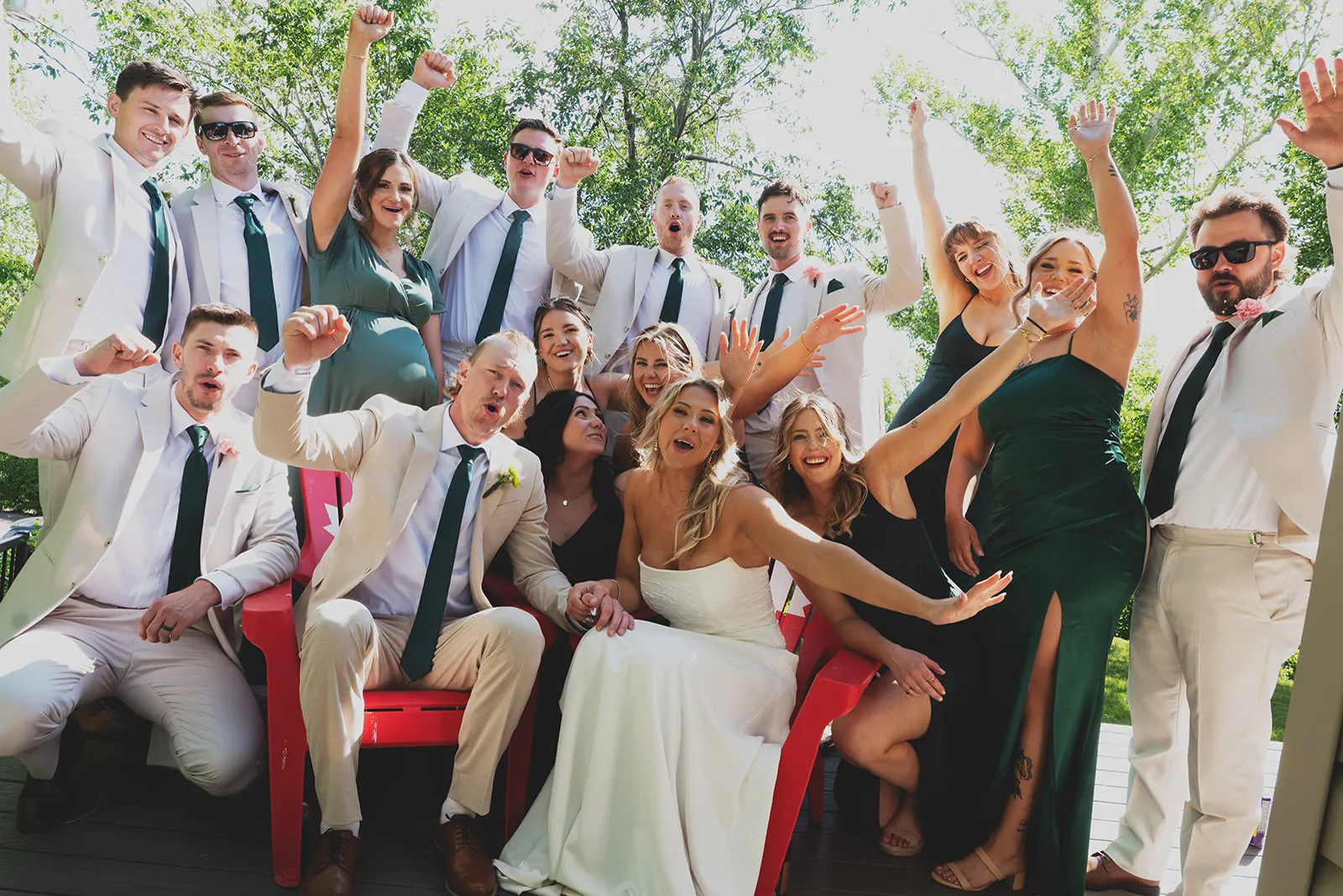 A wedding party cheering together outside